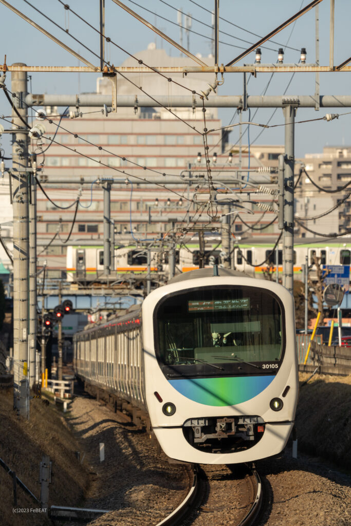本川越駅を発ち西武新宿線を南大塚へと走る30000系と、頭上を通るJR209系