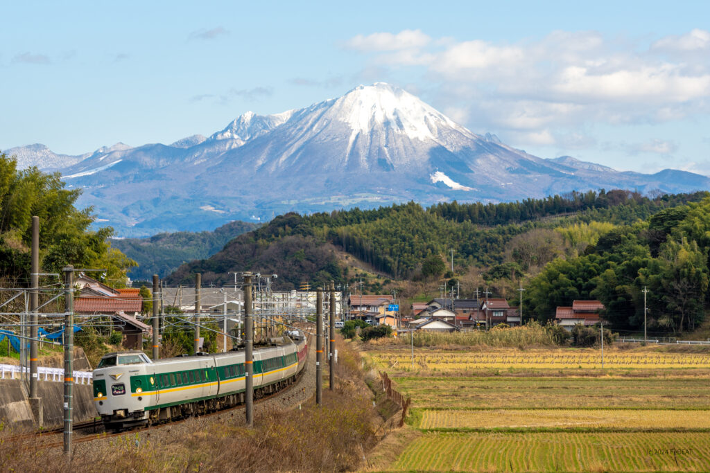 冠雪の大山を背に山陰本線を米子から安来へと走る緑やくも色編成の381系「やくも」